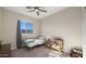 Charming bedroom with hardwood floors, a ceiling fan and window at 19711 W Georgia Ave, Litchfield Park, AZ 85340