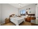 Cozy bedroom with a queen-size bed and wicker furniture at 19711 W Georgia Ave, Litchfield Park, AZ 85340