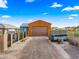 Attached garage with wood-like finish and driveway at 19711 W Georgia Ave, Litchfield Park, AZ 85340