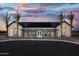Modern community center with solar panels and palm trees at sunset at 22693 E Happy Rd, Queen Creek, AZ 85142