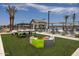 Resort-style pool with lounge chairs and outdoor games at 22693 E Happy Rd, Queen Creek, AZ 85142