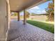 Covered patio and grassy backyard with brick pavers at 22794 E Via Las Brisas --, Queen Creek, AZ 85142
