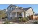 Two-story house with a neutral color scheme and a stone facade at 23013 E Domingo Rd, Queen Creek, AZ 85142