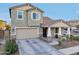 Two-story house with a neutral color scheme and a stone facade at 23013 E Domingo Rd, Queen Creek, AZ 85142