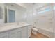 Bright bathroom with a vanity, large mirror, and a tub with a shower at 23048 E Watford Dr, Queen Creek, AZ 85142