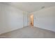 Bright bedroom with neutral carpet, showing doors to the hall and closet at 23048 E Watford Dr, Queen Creek, AZ 85142