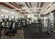 Modern gym with various equipment and large windows at 23048 E Watford Dr, Queen Creek, AZ 85142