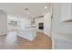 Stylish kitchen featuring stainless appliances, quartz counters, white cabinetry, and an open concept design at 23048 E Watford Dr, Queen Creek, AZ 85142