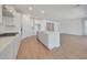 Open concept kitchen with stainless appliances, quartz countertops, large island, and sleek white cabinets at 23048 E Watford Dr, Queen Creek, AZ 85142