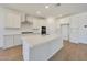 Modern kitchen with quartz island, stainless appliances, subway tile backsplash, and ample white cabinetry at 23048 E Watford Dr, Queen Creek, AZ 85142