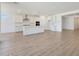 Expansive living space showcasing wood-look tile flooring, abundant natural light, and an open kitchen layout at 23048 E Watford Dr, Queen Creek, AZ 85142