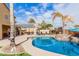 Large kidney shaped pool with a rock waterfall and putting green at 2315 S 173Rd Dr, Goodyear, AZ 85338