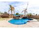 Relaxing kidney-shaped pool surrounded by palm trees and a spacious patio at 2315 S 173Rd Dr, Goodyear, AZ 85338