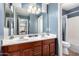 Bathroom with a double vanity, large mirror, and shower/tub combo at 2315 S 173Rd Dr, Goodyear, AZ 85338