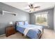 Bright bedroom with a double bed, nightstand, and ceiling fan at 2315 S 173Rd Dr, Goodyear, AZ 85338