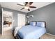 Bedroom with a double bed, access to game room, and ceiling fan at 2315 S 173Rd Dr, Goodyear, AZ 85338