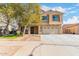 Two-story house with tan exterior, landscaped yard, and a two-car garage at 2315 S 173Rd Dr, Goodyear, AZ 85338