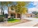 Two-story house with tan exterior, large tree in front, and a two-car garage at 2315 S 173Rd Dr, Goodyear, AZ 85338