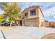 Two-story house with tan exterior, landscaped yard, and a two-car garage at 2315 S 173Rd Dr, Goodyear, AZ 85338