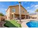 Two-story house with covered patio, putting green, and sparkling pool at 2315 S 173Rd Dr, Goodyear, AZ 85338