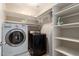 Laundry room with washer, dryer, and shelving at 2315 S 173Rd Dr, Goodyear, AZ 85338