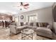 Spacious living room featuring a large sectional sofa and tile flooring at 2315 S 173Rd Dr, Goodyear, AZ 85338