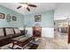 Living room with a brown leather sofa, coffee table, and fireplace at 2315 S 173Rd Dr, Goodyear, AZ 85338