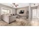 Living room with L-shaped sectional sofa and a large flat-screen TV at 2315 S 173Rd Dr, Goodyear, AZ 85338