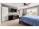 Bright main bedroom with fireplace, TV, and ensuite bathroom at 2315 S 173Rd Dr, Goodyear, AZ 85338