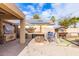 Gorgeous outdoor kitchen with built-in grill, pizza oven, and bar seating at 2315 S 173Rd Dr, Goodyear, AZ 85338
