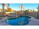 Inviting pool with a rock waterfall feature and patio at 2315 S 173Rd Dr, Goodyear, AZ 85338