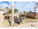 Elegant patio with lounge chairs near a stunning pool and outdoor fireplace at 2315 S 173Rd Dr, Goodyear, AZ 85338