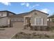 One-story home with a two-car garage and desert landscaping at 24241 W Agora Ln, Buckeye, AZ 85326