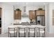 Bright kitchen features an island with seating and stainless steel appliances at 24241 W Agora Ln, Buckeye, AZ 85326