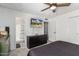 Bright bedroom with ensuite bathroom access and large TV at 2548 W Monte Cristo Ave, Phoenix, AZ 85023