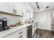 Clean and bright kitchen with white shaker cabinets and stainless steel appliances at 2548 W Monte Cristo Ave, Phoenix, AZ 85023