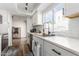 Modern kitchen with white cabinets, quartz countertops, and stainless steel appliances at 2548 W Monte Cristo Ave, Phoenix, AZ 85023