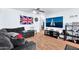 Living room with an L-shaped sofa, large TV, and wood flooring at 2949 E Wier Ave, Phoenix, AZ 85040