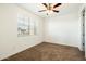 Bright bedroom with window and ceiling fan at 31957 N 125Th Ave, Peoria, AZ 85383