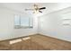 Well-lit bedroom with a large window and ceiling fan at 31957 N 125Th Ave, Peoria, AZ 85383