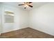 Cozy bedroom featuring a window and ceiling fan at 31957 N 125Th Ave, Peoria, AZ 85383