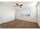 Bright bedroom featuring a large window and ceiling fan at 31957 N 125Th Ave, Peoria, AZ 85383