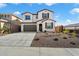 Two-story house with attached garage and landscaped front yard at 31957 N 125Th Ave, Peoria, AZ 85383