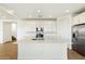 Modern kitchen with white cabinets, island, and stainless steel appliances at 31957 N 125Th Ave, Peoria, AZ 85383