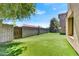 Landscaped backyard with artificial turf and wall at 3804 E Camelback Rd, Phoenix, AZ 85018