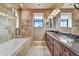 Bathroom with double vanity, soaking tub and tile shower at 3804 E Camelback Rd, Phoenix, AZ 85018