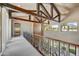 Upstairs hallway with wood beams and railing at 3804 E Camelback Rd, Phoenix, AZ 85018