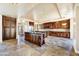 Large kitchen with island, ample cabinetry, and tile floors at 3804 E Camelback Rd, Phoenix, AZ 85018