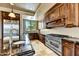 Gourmet kitchen featuring dark wood cabinetry and granite counters at 3804 E Camelback Rd, Phoenix, AZ 85018