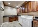 Laundry room with washer, dryer and wood cabinets at 3804 E Camelback Rd, Phoenix, AZ 85018